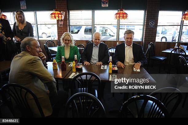 Republican presidential candidate John McCain , his wife Cindy , former Denver Broncos football player John Elway and businessman Greg Maffei sit...