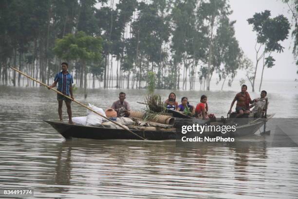 Bangladeshi flood victims moving on a boat to shelter center in Gaibandha, northern Bangladesh on August 15, 2017. More than 50 people have died in...