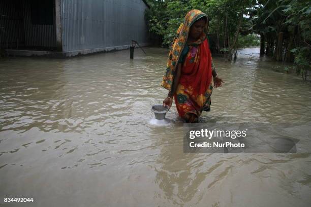 Bangladeshi woman collects drinking water from a tube well at a shelter center in Gaibandha, northern Bangladesh on August 15, 2017. More than 50...