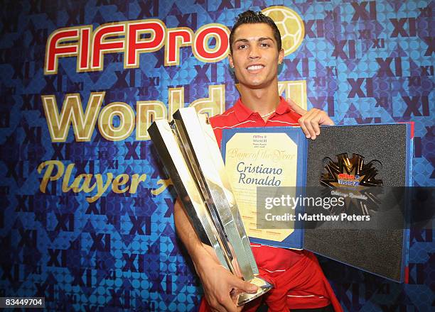 Cristiano Ronaldo of Manchester United poses with his FIFPRO World Player of the Year and World XI awards at Carrington Training Ground on October 27...