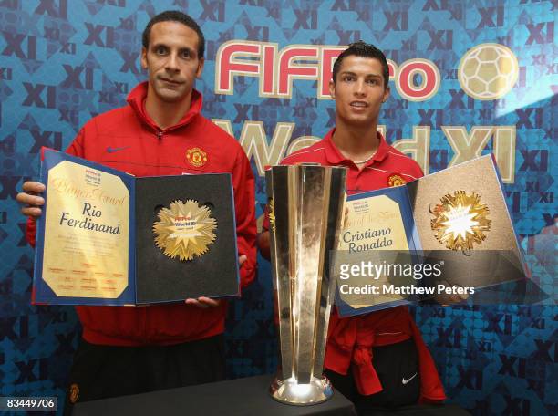Rio Ferdinand and Cristiano Ronaldo of Manchester United pose with their FIFPRO World Player of the Year and World XI awards at Carrington Training...