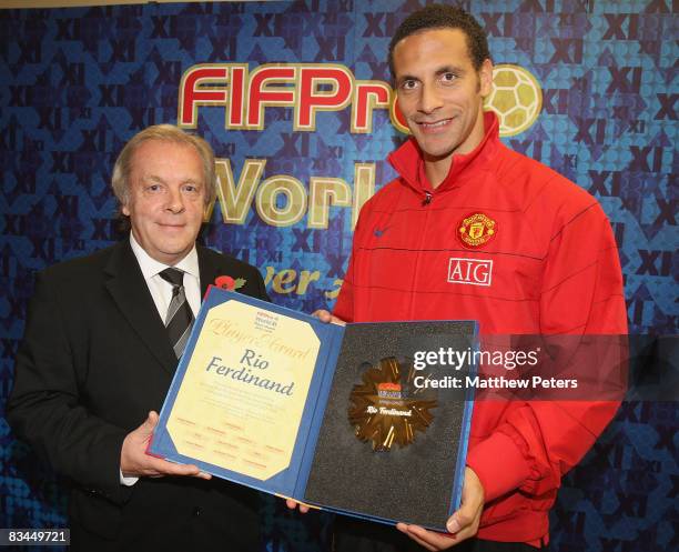 Rio Ferdinand of Manchester United is presented with his FIFPRO World XI award by Gordon Taylor of the PFA at Carrington Training Ground on October...