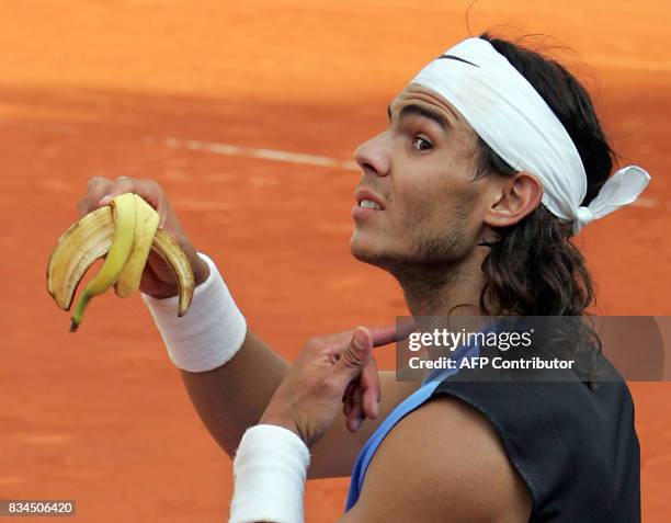 Spain's Rafael Nadal shows his throat after eating a banana during his match against France's Paul-Henri Mathieu on the center court of the French...