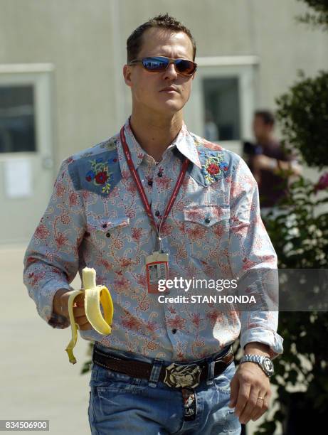 Ferrari driver Michael Schumacher of Germany walks through the paddock area, 29 June during preparations for the United States Grand Prix at...