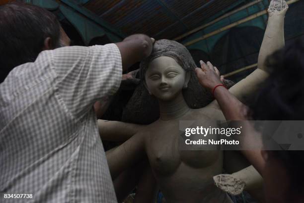Bangladeshi artist preparing a clay idol of Hindu deity Durga at a workshop ahead of Durga puja festival in Dhaka , Bangladesh on August 18, 2017....