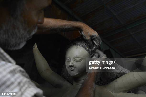 Bangladeshi artist prepares a clay idol of Hindu deity Durga at a workshop ahead of Durga puja festival in Dhaka , Bangladesh on August 18, 2017. The...