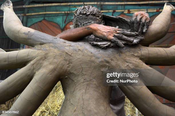 Bangladeshi artist prepares a clay idol of Hindu deity Durga at a workshop ahead of Durga puja festival in Dhaka , Bangladesh on August 18, 2017. The...