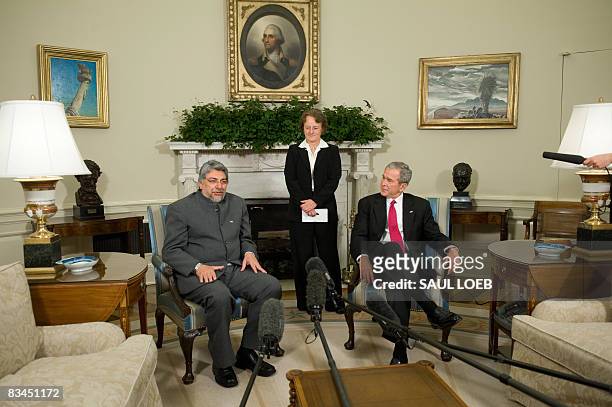 President George W. Bush listens alongside a translator as Paraguay's President Fernando Lugo speaks during meetings in the Oval Office of the White...