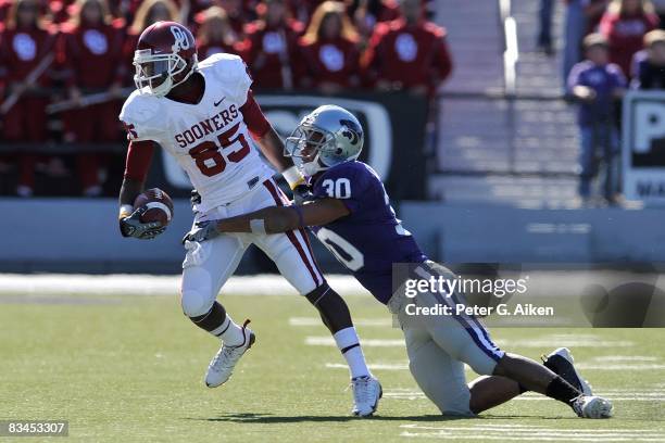 Free safety Chris Carney of the Kansas State Wildcats makes a tackle on wide receiver Ryan Broyles of the Oklahoma Sooners in the first half on...