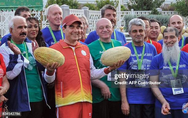 Turkmen President Gurbanguly Berdymukhamedov, surrounded by officials and participants of the upcoming 2017 Asian Indoor and Martial Arts Games,...