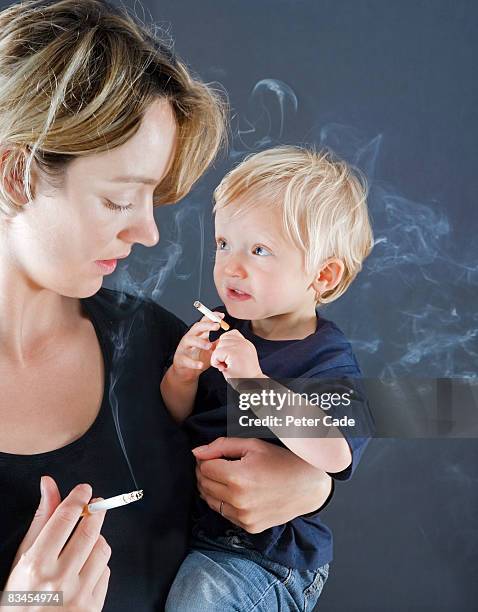 mother and baby son smoking - surprised mum stock-fotos und bilder