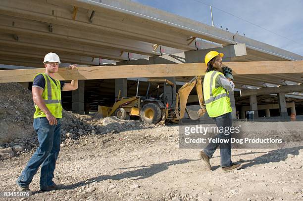 construction workers carrying materials - carry foundation stock-fotos und bilder