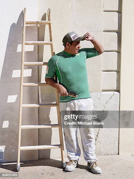 tradesman with his ladder looking down street - tradesman real people man stock pictures, royalty-free photos & images