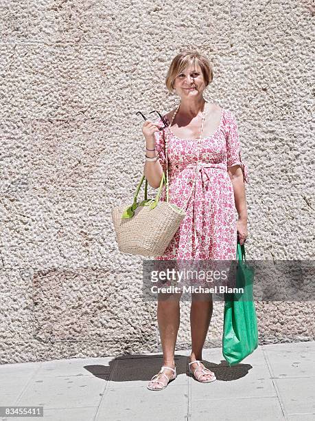 portrait of mature woman with shopping - woman short blond hair stock pictures, royalty-free photos & images