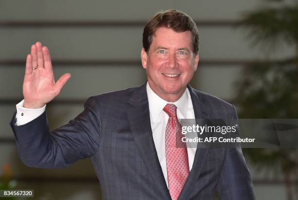 William Hagerty, the new US Ambassador to Japan, waves to the media upon his arrival at the prime minister's official residence to meet with Japan's...