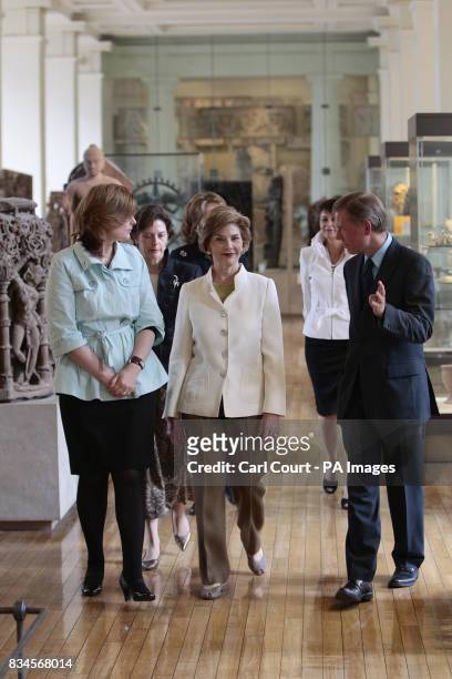 The wife of Britain's Prime Minister, Sarah Brown, left, walks with America's First Lady, Laura Bush, right, are shown around the Afghan and Burmese...