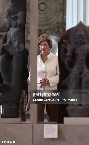 America's First Lady, Laura Bush, looks at an antique object during her tour of the British Museum, London.