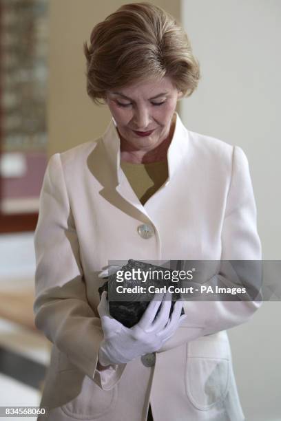 America's First Lady, Laura Bush looks at an antique object during her tour of the British Museum, London.