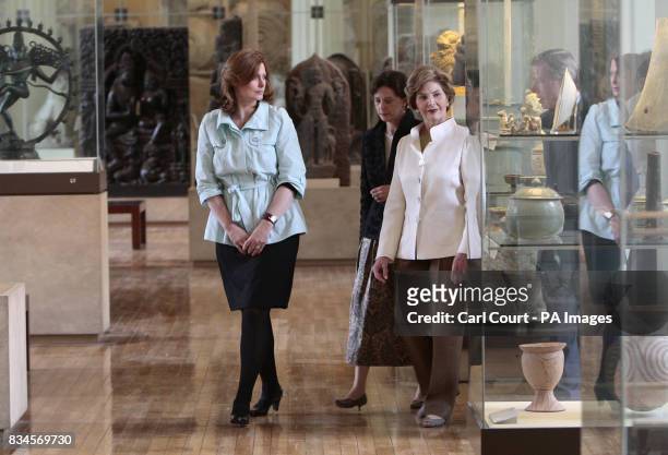 The wife of Britain's Prime Minister, Sarah Brown, left, walks with America's First Lady, Laura Bush, right, during their tour of the British Museum,...