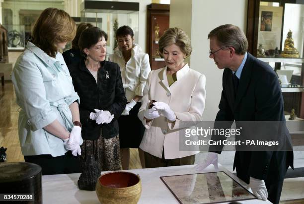 The wife of Britain's Prime Minister, Sarah Brown, left, looks on America's First Lady, Laura Bush, second right, is shown an ancient artifact in the...