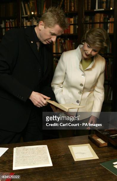 America's First Lady, Laura Bush, right, is shown Charles Dickens writing journal detailing his travels in America, by Andrew Xavier, the museum...