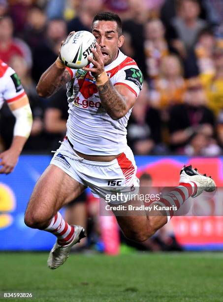 Paul Vaughan of the Dragons dives over to score a try during the round 24 NRL match between the Brisbane Broncos and the St George Illawarra Dragons...