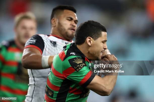 Cody Walker of the Rabbitohs is pushed by Ken Maumalo of the Warriors during the round 24 NRL match between the South Sydney Rabbitohs and the New...