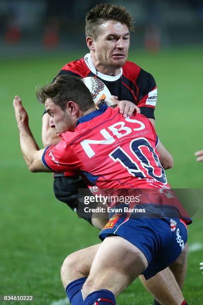 Mitchell Hunt of Tasman tackles George Bridge during the during the Mitre 10 Cup round one match between Tasman and Canterbury at Trafalgar Park on...