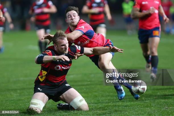 Mitchell Dunshea of Canterbury juggles the ball as he is tackled by Mitchell Hunt during the during the Mitre 10 Cup round one match between Tasman...