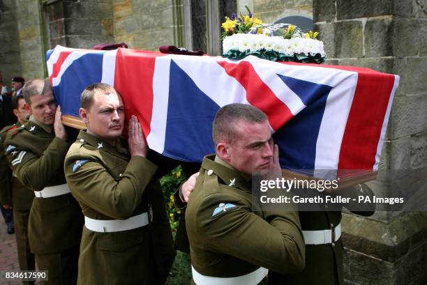 The coffin of Private Daniel Gamble of B Company 2nd Battalion Parachute Regiment is carried by colleagues out of the Holy Cross Church in Uckfield,...