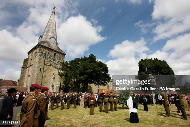 The coffin of Private Daniel Gamble of B Company 2nd Battalion Parachute Regiment is carried by colleagues into the grounds of the Holy Cross Church...