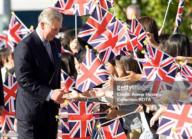 Prince Charles, Prince of Wales greets flag waving schoolchildren as he arrives at the Emerging Museum of Science and Innovation on October 28, 2008...