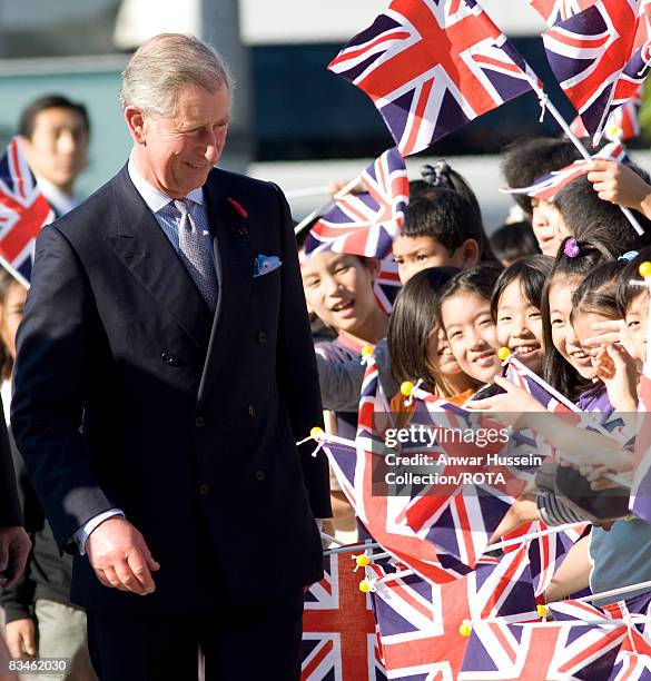 Prince Charles, Prince of Wales greets flag waving schoolchildren as he arrives at the Emerging Museum of Science and Innovation on October 28, 2008...