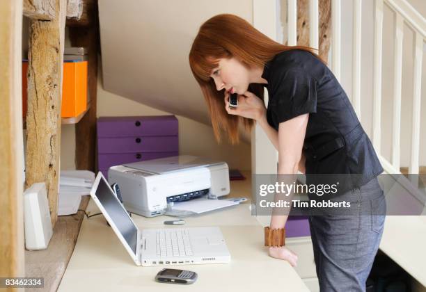 young business woman using mobile in home office - imprimante photos et images de collection