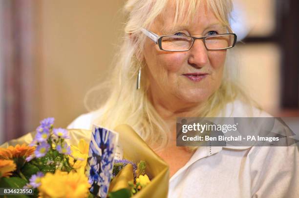 Aneira Thomas, the first baby to be born on the NHS, receives flowers from the First Minister of the National Assembly for Wales Rhodri Morgan, not...