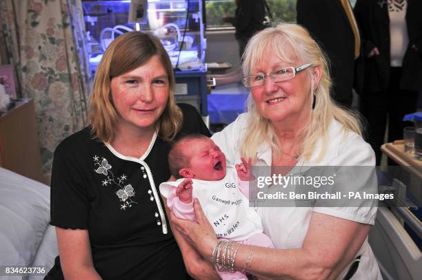 Aneira Thomas, the first baby to be born on the NHS, holds Andrea Davies's newborn baby Kimberley, who was born on Monday 23 June 2008. Singleton...