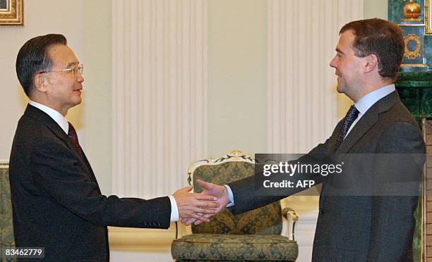 Russian President Dmitry Medvedev shakes hands with Chinese Premier Wen Jiabao in Moscow on October 28, 2008. Russia and China signed a long-awaited...