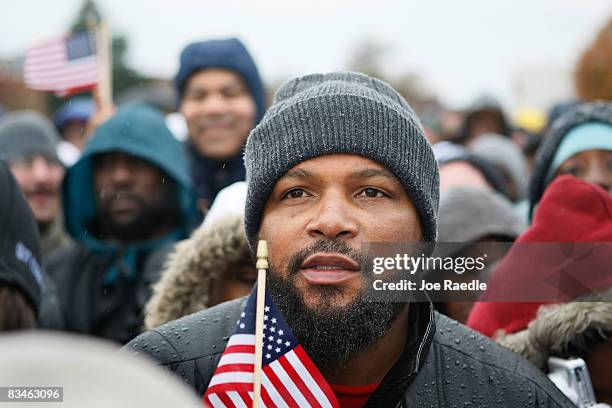 People listen as Democratic presidential nominee U.S. Sen. Barack Obama speaks in the rain during a campaign rally at Widener University Main Quad...