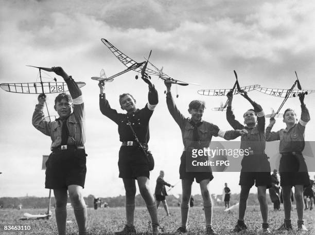 German boys wearing Hitler Youth uniforms playing with model airplanes powered by elastic bands, 29th June 1936.