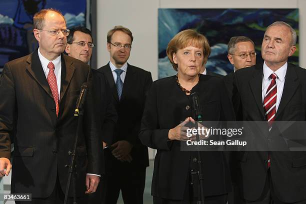German Chancellor Angela Merkel and Finance Minister Peer Steinbrueck , accompanied by finance experts, talk to the media after meeting with the...