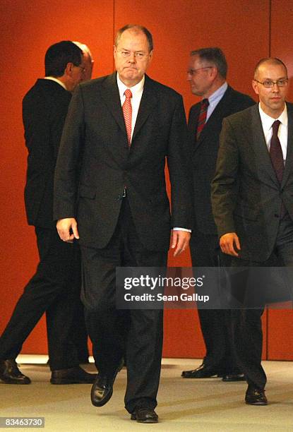 German Finance Minister Peer Steinbrueck , accompanied by finance experts, emerges from a meeting with the experts and Chancellor Angela Merkel at...