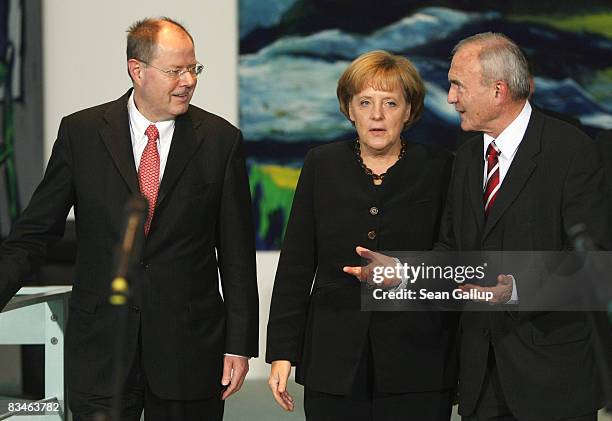 German Chancellor Angela Merkel, Finance Minister Peer Steinbrueck and chief economist of the European Central Bank Otmar Issinger arrive to talk to...