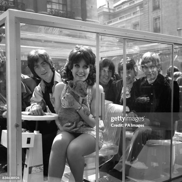 With a Metro-Goldwyn-Mayer lion cub on her lap, Sheila Carter is shown with four of her companions who make up their group, 'Episode Six' - Roger...