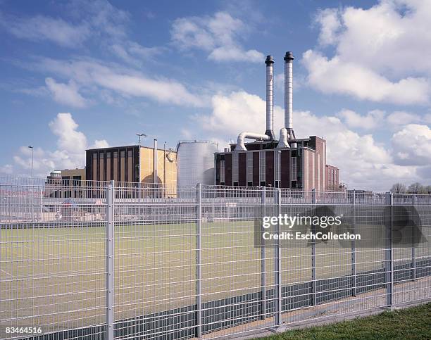 city heating plant with exhaust pipes. - district heating plant stock-fotos und bilder