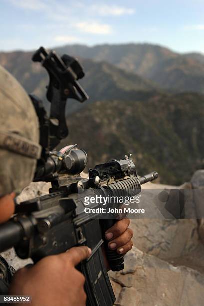 Army Pvt. Jerry Chavez aims towards a Taliban position October 28, 2008 in the Korengal Valley in eastern Afghanistan. American forces from 2nd...