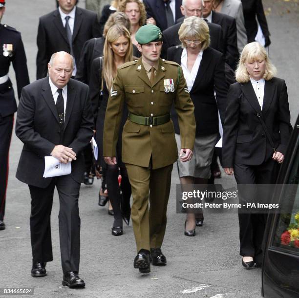 The parents of Corporal Sarah Bryant Des and Maureen Feely accompany her husband Corporal Carl Bryant as they follow her coffin to her funeral at...