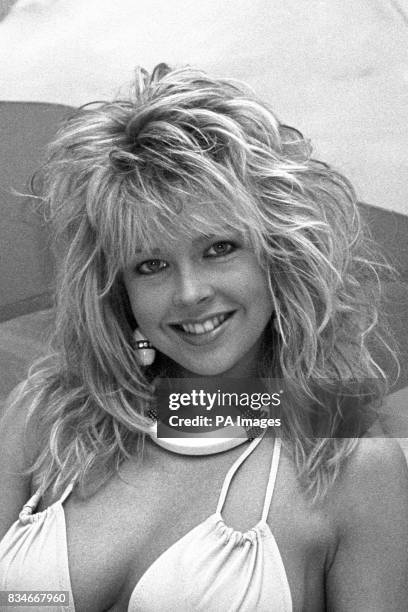 Model Corinne Russell sports a big tousled beach blonde hairstyle popular in the eighties.