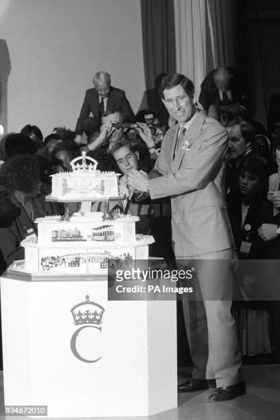 The Prince of Wales cuts the birthday cake made for him at a huge party to celebrate his 40th birthday today, in a once derelict tramshed in...