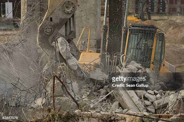 Demoliton machine crushes a concrete wall at the stripped remains of the former Palace of the Republic on October 28, 2008 in Berlin, Germany. The...