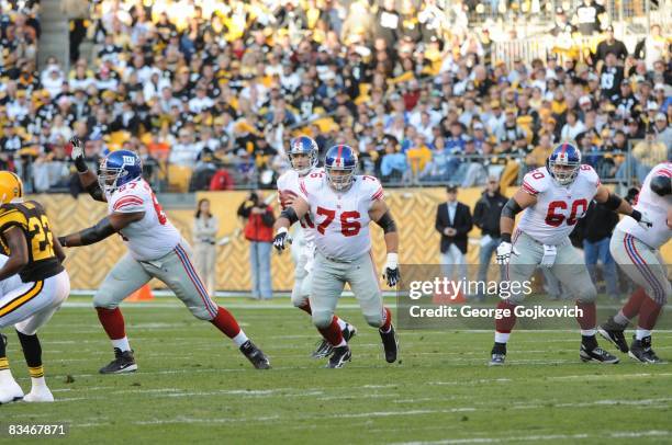 Offensive linemen Kareem McKenzie, Chris Snee and Shaun O'Hara of the New York Giants block as quarterback Eli Manning drops back to pass against the...